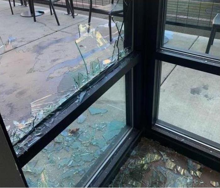 A smashed window is pictured at a popular coffee chain.